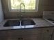 White kitchen with stainless steel sink and granite countertops at 1434 Cleveland St # 4, Clearwater, FL 33755