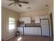 White kitchen with appliances and wood flooring at 1434 Cleveland St # 4, Clearwater, FL 33755