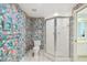 Bathroom with shower stall, toilet and patterned wallpaper at 1540 Gulf Blvd # 2004, Clearwater, FL 33767