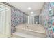 Spa-like bathroom with a large bathtub and patterned wallpaper at 1540 Gulf Blvd # 2004, Clearwater, FL 33767