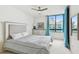 Bedroom with a queen-size bed, dresser, and ocean view at 1540 Gulf Blvd # 2004, Clearwater, FL 33767