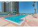 Resort-style swimming pool with adjacent building at 1540 Gulf Blvd # 2004, Clearwater, FL 33767