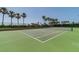 Well-maintained tennis court surrounded by palm trees at 1540 Gulf Blvd # 2004, Clearwater, FL 33767