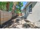 Backyard with grassy area, wooden fence, and side of house at 1584 S Washington Ave, Clearwater, FL 33756