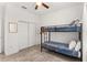 Bedroom with a bunk bed, closet, and rug at 1584 S Washington Ave, Clearwater, FL 33756