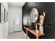 Modern entryway with a dark accent wall, wood console table, and framed artwork at 1584 S Washington Ave, Clearwater, FL 33756