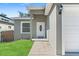 Gray exterior home with a white front door and walkway leading to the entrance at 1584 S Washington Ave, Clearwater, FL 33756