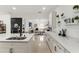 Open concept kitchen with white cabinets, island, and views into the living room at 1584 S Washington Ave, Clearwater, FL 33756