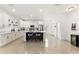 Modern kitchen boasting white shaker cabinets, an island with seating, and stainless steel appliances at 1584 S Washington Ave, Clearwater, FL 33756