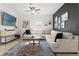 Bright living room featuring a large sectional sofa, stylish coffee table, and a wall-mounted TV at 1584 S Washington Ave, Clearwater, FL 33756