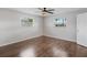 Bright bedroom with wood-look floors and ceiling fan at 1768 Algonquin Dr, Clearwater, FL 33755