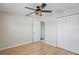 Bedroom with ceiling fan and large closet, light wood flooring at 1768 Algonquin Dr, Clearwater, FL 33755