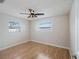 Spacious bedroom with ceiling fan and light wood flooring at 1768 Algonquin Dr, Clearwater, FL 33755