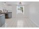 Bright dining area with tile flooring and a large window overlooking backyard at 1768 Algonquin Dr, Clearwater, FL 33755