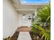 Front entrance with tiled porch and landscaping at 1768 Algonquin Dr, Clearwater, FL 33755