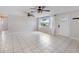 Living room with tile floors, ceiling fans, and window at 1768 Algonquin Dr, Clearwater, FL 33755