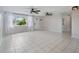 Living room with tile floors, ceiling fans, and window at 1768 Algonquin Dr, Clearwater, FL 33755