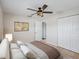 Main bedroom with ceiling fan, large closet, and ensuite bathroom at 1768 Algonquin Dr, Clearwater, FL 33755