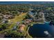 Aerial view of community with lake and buildings at 1882 Pine Ridge W Way # E1, Palm Harbor, FL 34684