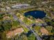 Aerial view of community near highway and lake at 1882 Pine Ridge W Way # E1, Palm Harbor, FL 34684