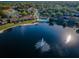 Aerial view of community by the lake with fountain at 1882 Pine Ridge W Way # E1, Palm Harbor, FL 34684