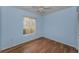 Light blue bedroom with wood-look tile flooring and ceiling fan at 1882 Pine Ridge W Way # E1, Palm Harbor, FL 34684