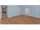 Light blue bedroom with wood-look floors at 1882 Pine Ridge W Way # E1, Palm Harbor, FL 34684