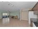 View of kitchen with dark wood cabinets and tile floors at 1882 Pine Ridge W Way # E1, Palm Harbor, FL 34684