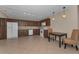 Kitchen featuring dark wood cabinets, granite countertops, and white appliances at 1882 Pine Ridge W Way # E1, Palm Harbor, FL 34684