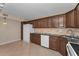 Bright kitchen with dark wood cabinets and granite countertops at 1882 Pine Ridge W Way # E1, Palm Harbor, FL 34684