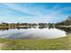 Serene lake view with fountain and lush landscaping at 1882 Pine Ridge W Way # E1, Palm Harbor, FL 34684