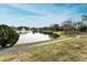 Relaxing lakeside walking path with green space at 1882 Pine Ridge W Way # E1, Palm Harbor, FL 34684