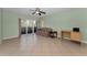 Living room with tile floors, sliding glass doors, and a ceiling fan at 1882 Pine Ridge W Way # E1, Palm Harbor, FL 34684