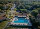 Community pool, shuffleboard, and surrounding buildings at 1882 Pine Ridge W Way # E1, Palm Harbor, FL 34684