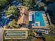 Community pool, shuffleboard, and parking area at 1882 Pine Ridge W Way # E1, Palm Harbor, FL 34684