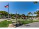 Community shuffleboard area with picnic tables at 1882 Pine Ridge W Way # E1, Palm Harbor, FL 34684