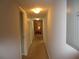 Long hallway with carpet flooring and multiple doors leading to bedrooms at 1950 59Th N Ave # 110, St Petersburg, FL 33714