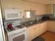 Kitchen with white cabinets and modern appliances at 1950 59Th N Ave # 110, St Petersburg, FL 33714