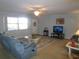 Bright living room with large windows and a cozy seating arrangement at 1950 59Th N Ave # 110, St Petersburg, FL 33714