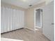 Bright bedroom with vinyl flooring and mirrored closet doors at 1955 Whitney Way, Clearwater, FL 33760