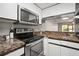 Kitchen with stainless steel appliances and marble countertops at 1955 Whitney Way, Clearwater, FL 33760