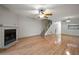 Living room with hardwood floors, fireplace and kitchen view at 1955 Whitney Way, Clearwater, FL 33760