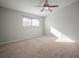 Main bedroom with neutral carpeting and large window at 1955 Whitney Way, Clearwater, FL 33760