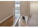 Upstairs hallway with view of living area and fireplace at 1955 Whitney Way, Clearwater, FL 33760