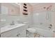 Clean bathroom with white tile and a bathtub at 2 N Fernwood Ave # 16, Clearwater, FL 33765