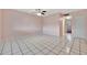 Spacious bedroom with tile floors and ceiling fan at 2 N Fernwood Ave # 16, Clearwater, FL 33765