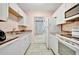 Efficient kitchen with white cabinets and appliances at 2 N Fernwood Ave # 16, Clearwater, FL 33765