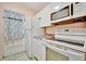 Efficient kitchen with white cabinets and appliances at 2 N Fernwood Ave # 16, Clearwater, FL 33765