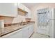 Bright kitchen featuring white cabinets, double sink and modern appliances at 2 N Fernwood Ave # 16, Clearwater, FL 33765