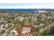 Aerial view of a single-Gathering home with a landscaped yard, located in a residential neighborhood near the water at 2004 Virginia Dr, Bradenton, FL 34205